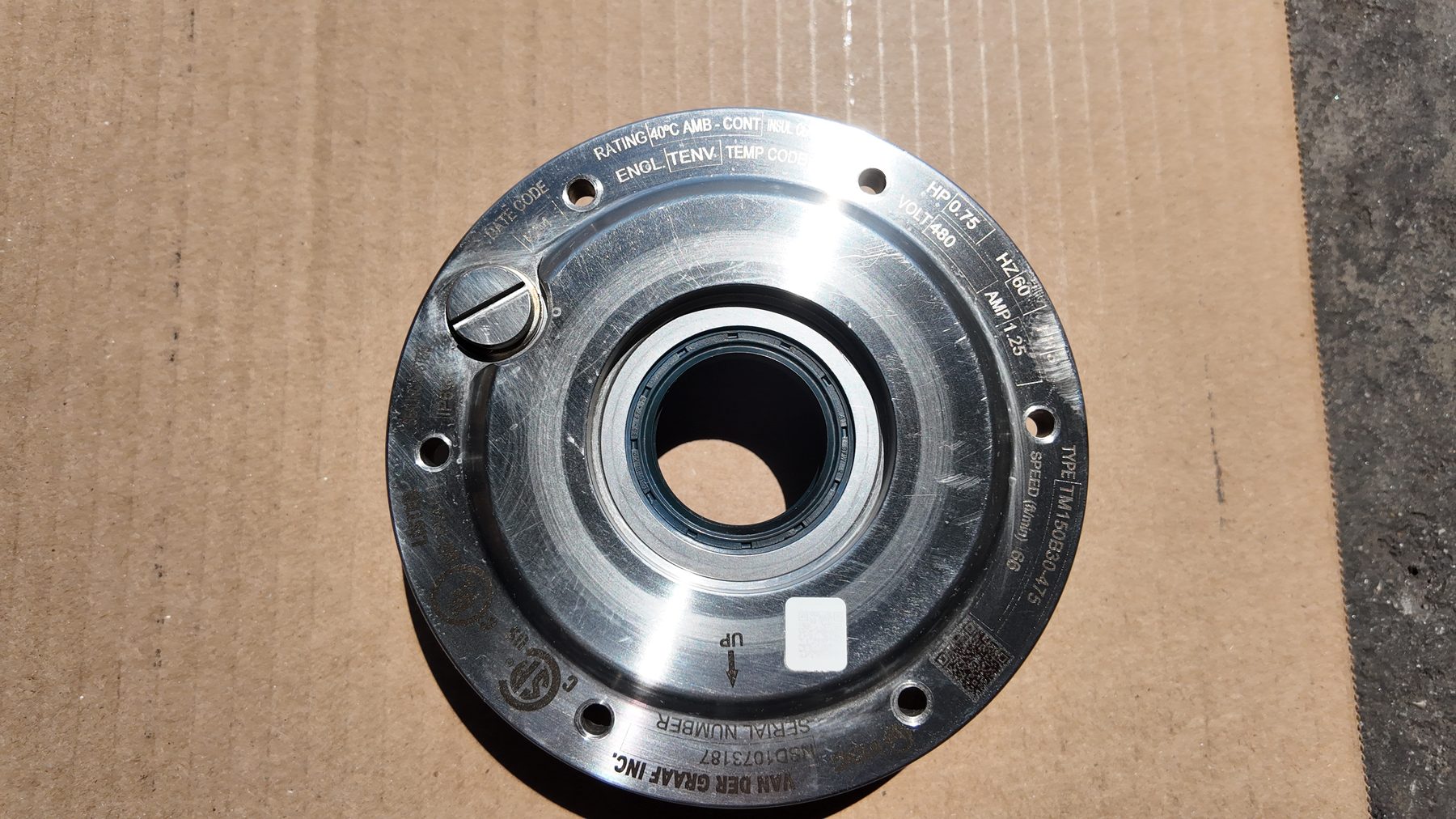 Stainless steel drum motor end flange with the engraved Van der Graaf nameplate
