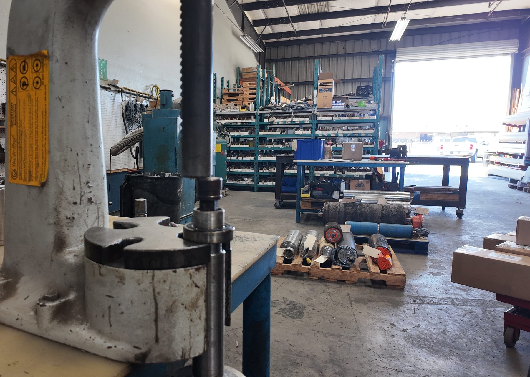 Repair shop floor with drum motors staged for service